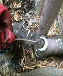 Entering Blocked Shower Drain with hand drain cleaning cables